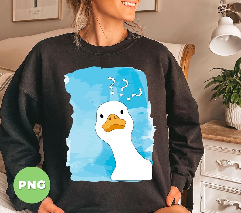 May include: A black sweatshirt with a white duck cartoon wearing a confused expression. The duck is surrounded by a blue watercolor background with question marks. The text on the sweatshirt reads '???'. 