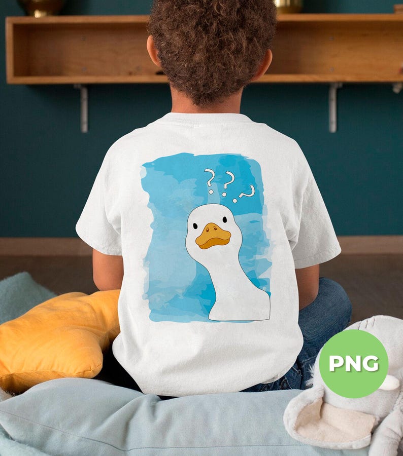 May include: A white t-shirt with a blue watercolor background and a white goose with a yellow beak and orange eyes looking over its shoulder. The goose has question marks above its head. The t-shirt is being worn by a person.