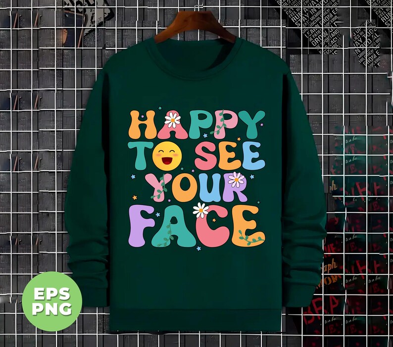 May include: A dark green sweatshirt with a colorful graphic print that says "Happy to see your face". The graphic features a smiling emoji with flowers and vines.