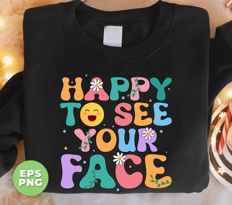 May include: Black sweatshirt with a colorful graphic design that says "Happy to see your face". The graphic features a smiling emoji, flowers, and vines.
