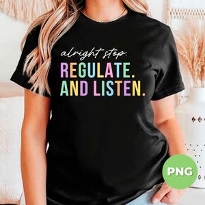May include: Black t-shirt with the text "alright stop. REGULATE. AND LISTEN." in pastel colors. The shirt has short sleeves and a crew neck.