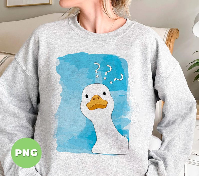 May include: A gray sweatshirt with a white duck with a blue watercolor background. The duck has a confused expression and question marks above its head. The text on the sweatshirt reads '???'.