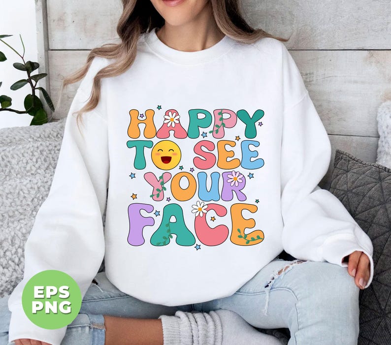 May include: White sweatshirt with a colorful graphic that says "Happy to see your face" with a smiley face and flowers.