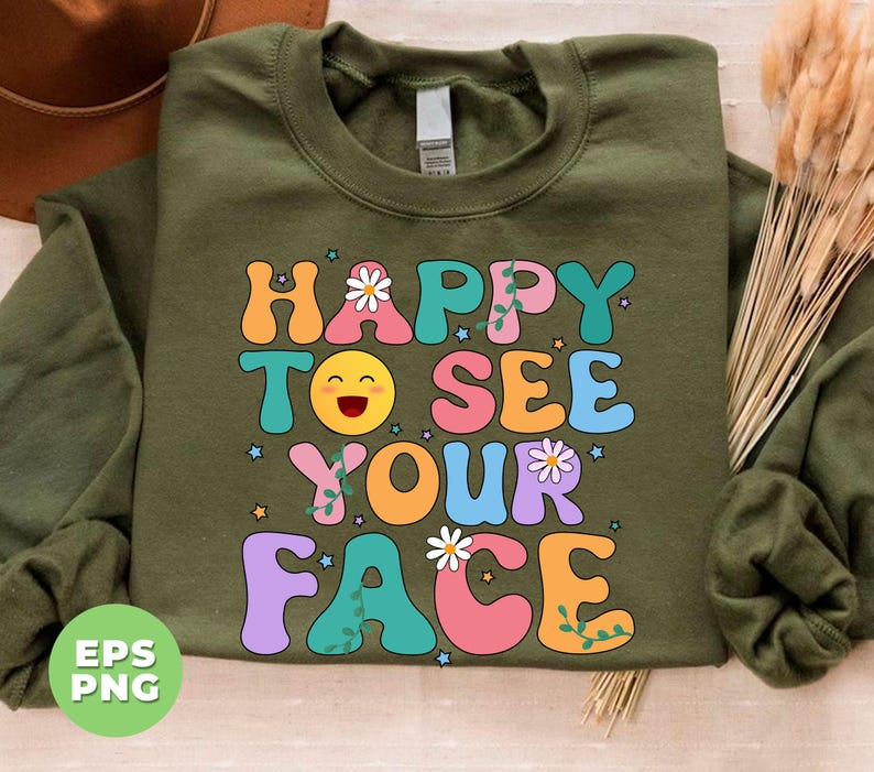 May include: Green sweatshirt with a retro-style graphic that says "Happy to see your face" in colorful letters with a smiling emoji and flowers.