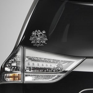 May include: White vinyl decal featuring an open book with flowers and the text "JUST ONE MORE chapter". The decal is designed to be applied to a car window or other smooth surface. Perfect for book lovers.