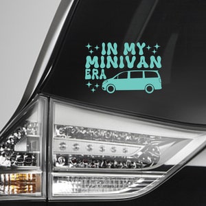 May include: A teal blue minivan silhouette with the text "IN MY MINIVAN ERA" and sparkling stars on a black car window.