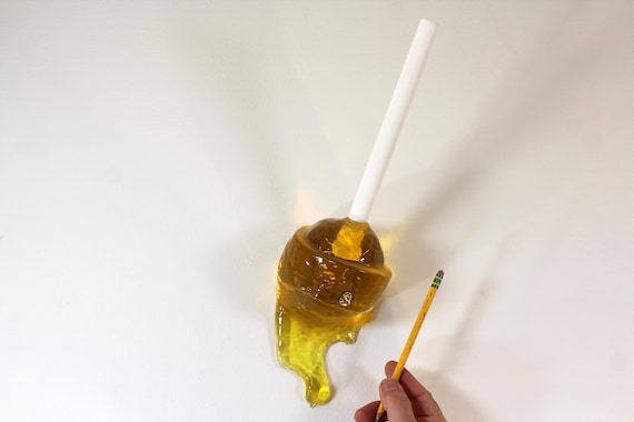 Giant wall blow pop lollypop tootsie pop melting down the wall citric lemon yellow resin sculpture find out more.