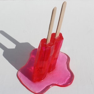 Resin twin popsicle double stick melting sucker sculptures, bright red, find out more.