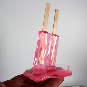 Resin twin popsicle double stick melting sucker sculptures hot pink find out more.