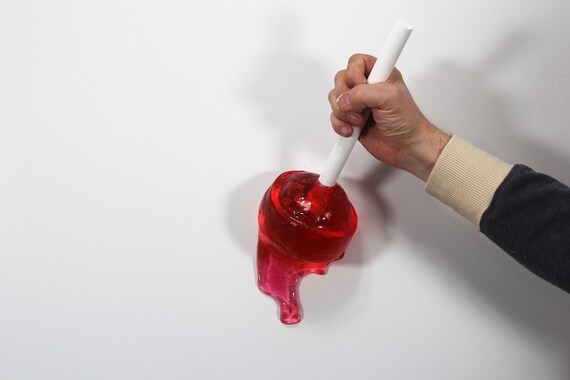 Giant wall blow pop lollypop tootsie pop melting down the wall resin sculpture find out more.