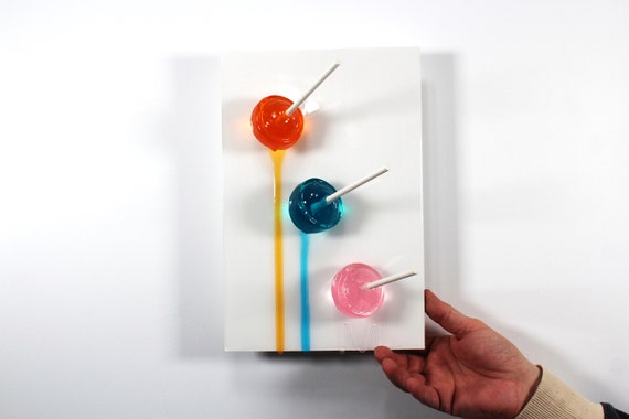 Blow pops melting down the wall 3D art.  Colorful fun resin wall art.