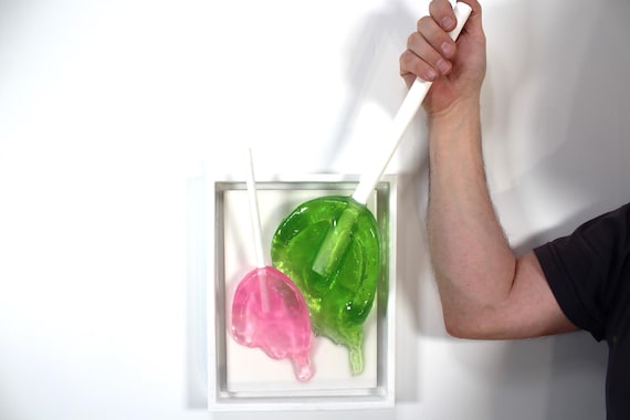 Colorful oversized resin suckers melting down the wall 3D art.  Fun wall art find out more.