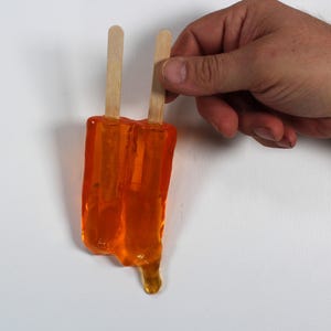 Wall hanging resin twin popsicle double stick melting sucker sculptures citric orange find out more.