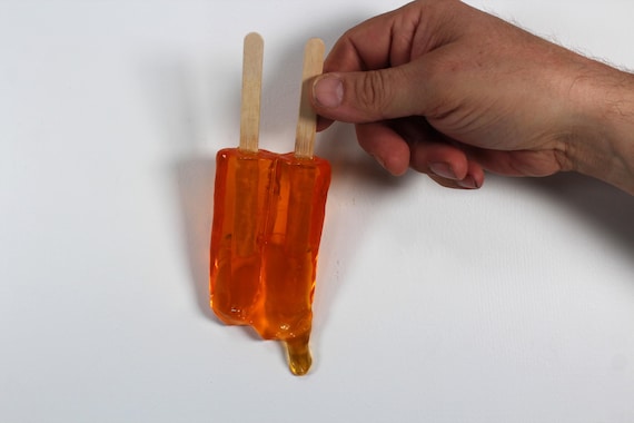 Wall hanging resin twin popsicle double stick melting sucker sculptures citric orange find out more.