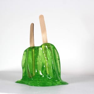 Resin twin popsicle double stick melting sucker sculpture lime green find out more.