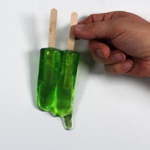 Wall hanging resin twin popsicle double stick melting sucker sculptures lime green find out more.