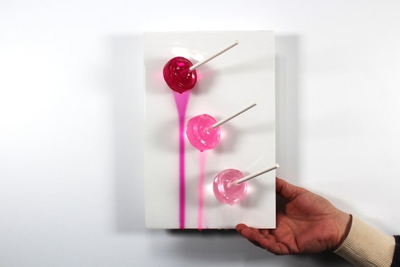 Blow pops melting down the wall 3D art.  Colorful fun resin wall art.