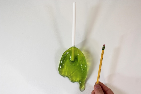 Wall hanging resin candy melting sucker sculpture citric lime green 11 inches long find out more.