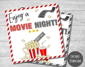 May include: Printable movie night ticket with red and white stripes, a film reel, popcorn, a drink, and the text "Enjoy a Movie Night!" and "Admit One".