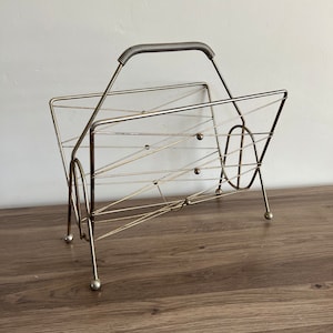Large Vintage metal record holder or magazine holder. Mcm atomic brass silver colored