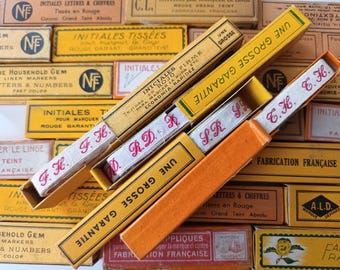 Vintage French monogrammed laundry labels with initials, for marking linen.
