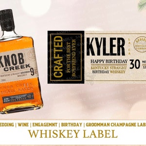 May include: A brown whiskey bottle label with gold lettering that reads "Knob Creek Kentucky Straight Bourbon Whiskey" and "Small Batch 9". The label also includes a birthday message that reads "Kyler Happy Birthday 30 May 12 Kentucky Straight Birthday Whiskey".