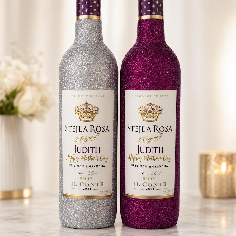 May include: Two wine bottles with glitter coatings, one silver and one magenta. Each label features a crown icon, the text Stella Rosa L'Originale, the name Judith, Happy Mother's Day, Best Mom & Grandma, May 9th, Il Conte 2021, and 750ml 25.4 fl oz.