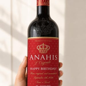 May include: A dark glass wine bottle with a red label featuring a gold crown icon and the text ANAHIS L'Originale, HAPPY BIRTHDAY!, Rare, original, and unmatched, September 4th, 2026, Semi-Sweet, IL CONTE 1917, and Stella Rosa on the red screw cap.