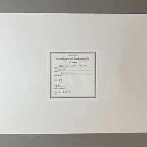 May include: A certificate of authenticity for a Hampton Court Place artwork, signed by GT Quinn and dated 3. 2023. The artwork is on paper and measures 30x40cm.