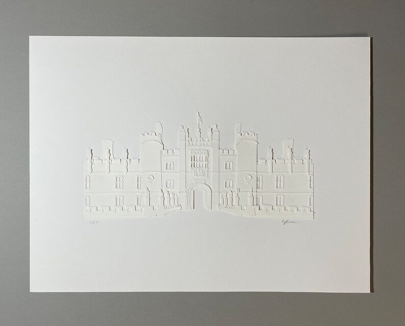May include: A white paper cut-out of a large building with a central archway and multiple windows. The building is reminiscent of a castle or manor house. The artwork is signed "G.L. Owen" in the bottom right corner.