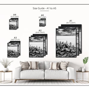 May include: Black and white framed art prints in various sizes, including A1 (33.1" x 23.4") to A5 (8.3" x 5.8"). The prints depict a landscape with cacti and a cloudy sky. The text "Size Guide - A1 to A5" is visible.