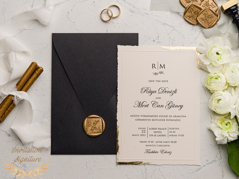May include: A wedding invitation with a gold and white design. The invitation features the couple's names, "R&uuml;ya Denizli and Mert Can G&uuml;ney", and the date of their wedding, "May 22, 2023". The invitation also includes the location of the wedding, "Lords Palace Hotel, Spa & Casino", and the time of the ceremony, "6:30 PM".