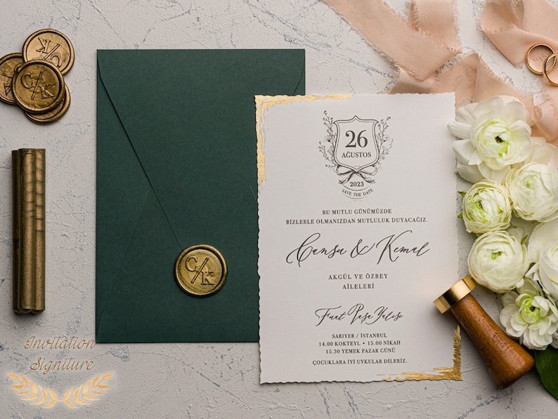 May include: A wedding invitation with gold accents and a green envelope. The invitation features a crest with the date "26 August 2023" and the names "Gense & Kemal". The text reads "BU MUTLU G&Uuml;N&Uuml;M&Uuml;ZDE BIZLERLE OLMANIZDAN MUTLULUK DUYACAĞIZ. AKG&Uuml;L VE &Ouml;ZBEY AİLELERİ Fast Pase Velese SARIYER/ISTANBUL 14.00 KOKTEIL 15.00 NIKAH 15.30 YEMEK PAZAR G&Uuml;NE &Ccedil;OCUKLARA ITI UYKULAR DİLERIZ."