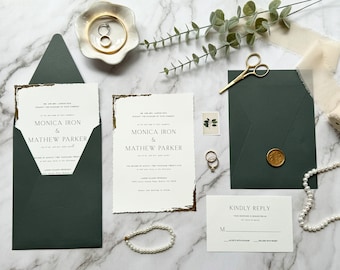 May include: Wedding invitation suite with a dark green envelope, white card with gold accents, and a RSVP card. The invitation features the names "Monica Iron & Mathew Parker" in a minimalist font.