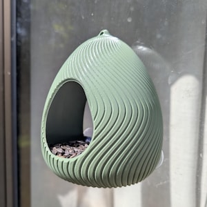 Textured egg-shaped window bird feeder with wave effect and suction cup attachment for balcony, olive green, garden decoration