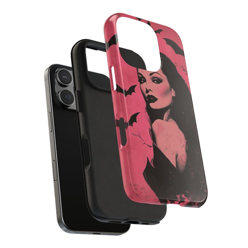 May include: A black smartphone with a black case and a pink case featuring a vintage illustration of a woman with bats. The pink case has a glossy finish and a cutout for the camera.