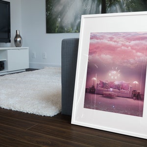 May include: A framed print of a pink and white living room with a couch, pillows, and lamps. The room is decorated with a cloud-like ceiling and stars.