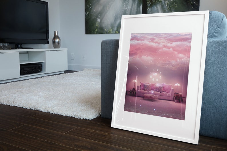 May include: A framed print of a pink and white living room with a couch, pillows, and lamps. The room is decorated with a cloud-like ceiling and stars.