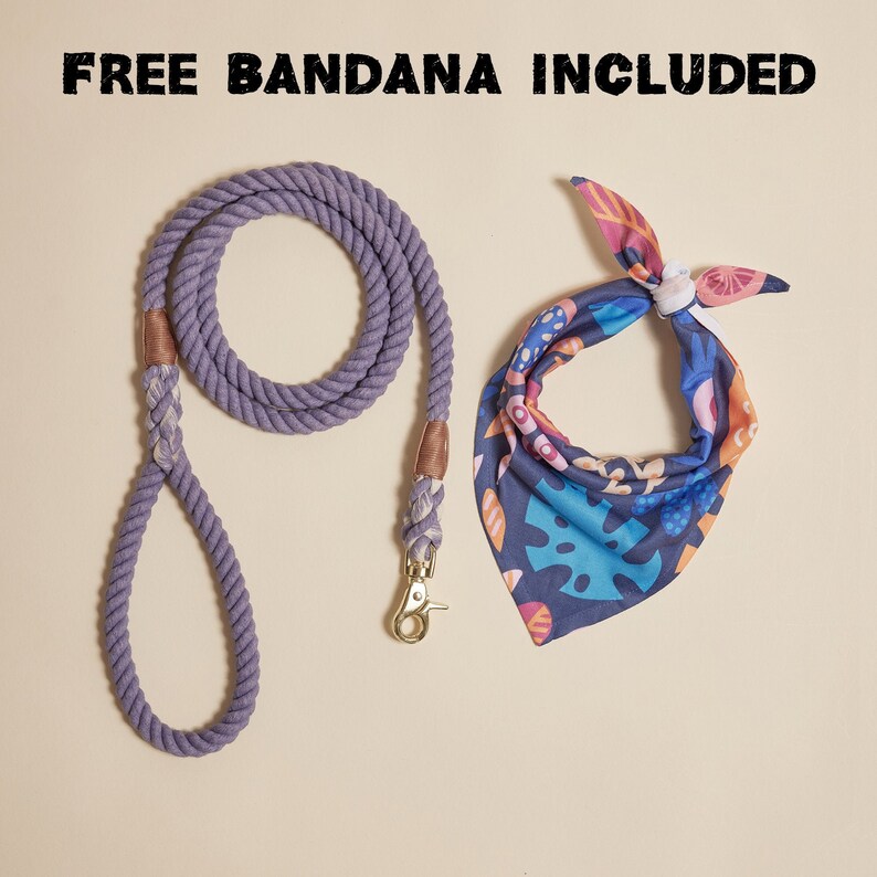 May include: A purple cotton rope dog leash with a gold metal clip and a colorful floral bandana. The text "FREE BANDANA INCLUDED" is at the top of the image.