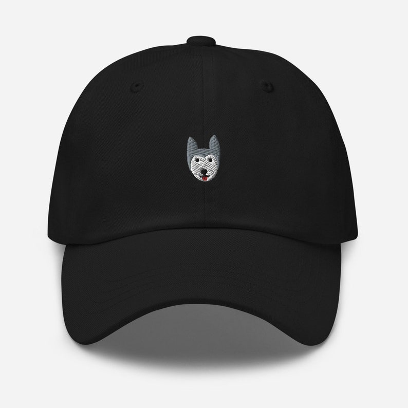 May include: A black baseball cap with an embroidered gray and white husky dog face on the front.
