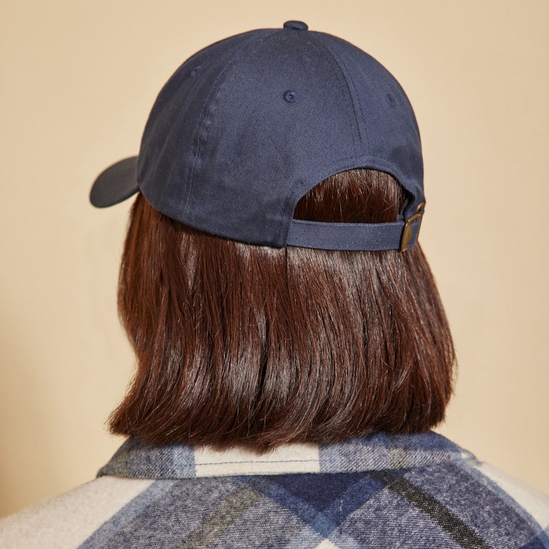 May include: A navy blue baseball cap with a curved brim and an adjustable strap.