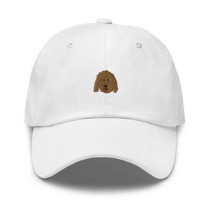 May include: White baseball cap with a brown embroidered dog face on the front.