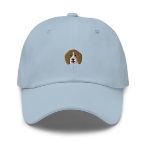 May include: A light blue baseball cap with an embroidered beagle dog face on the front.