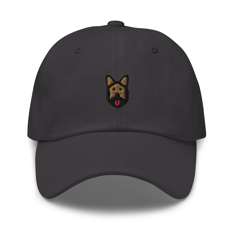 May include: A dark gray baseball cap with an embroidered German Shepherd dog face on the front.