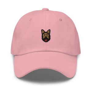 May include: A pink baseball cap with an embroidered German Shepherd dog face.
