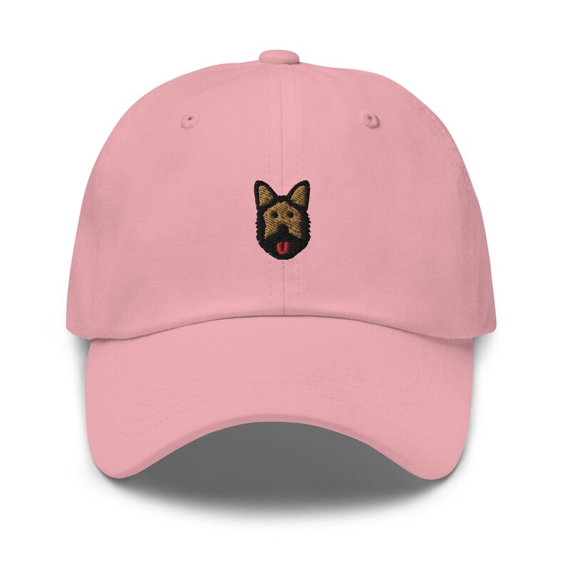 May include: A pink baseball cap with an embroidered German Shepherd dog face.