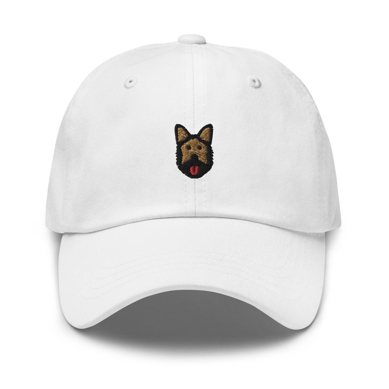 May include: White baseball cap with an embroidered brown and black German Shepherd dog face with a red tongue.
