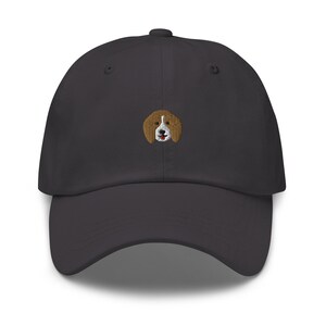 May include: A dark gray baseball cap with an embroidered beagle dog design.