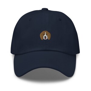 May include: A navy blue baseball cap with an embroidered beagle dog design.