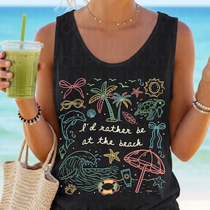 May include: Black tank top with a colorful beach-themed graphic. The design includes a dolphin, palm trees, sunglasses, a wave, and the text "I'd rather be at the beach."